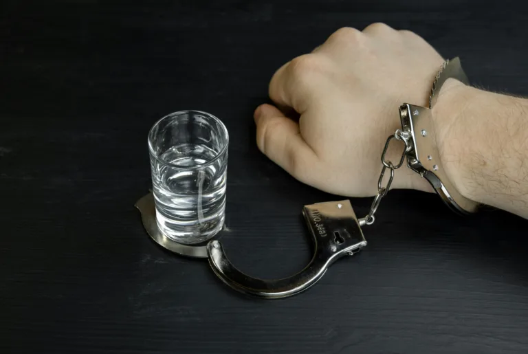hand handcuffed to a glass representing a dui conviction