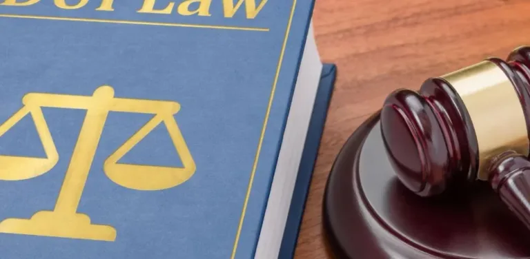 Close-up of legal textbook and courtroom gavel symbolizing criminal defense law
