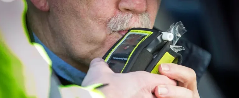 Close-up of DUI breath test device as driver blows into mouthpiece