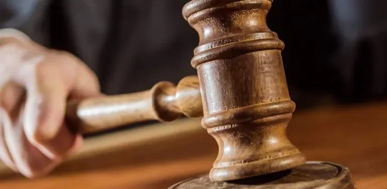 Close-up of a judge striking a wooden gavel on the bench to give a ruling.