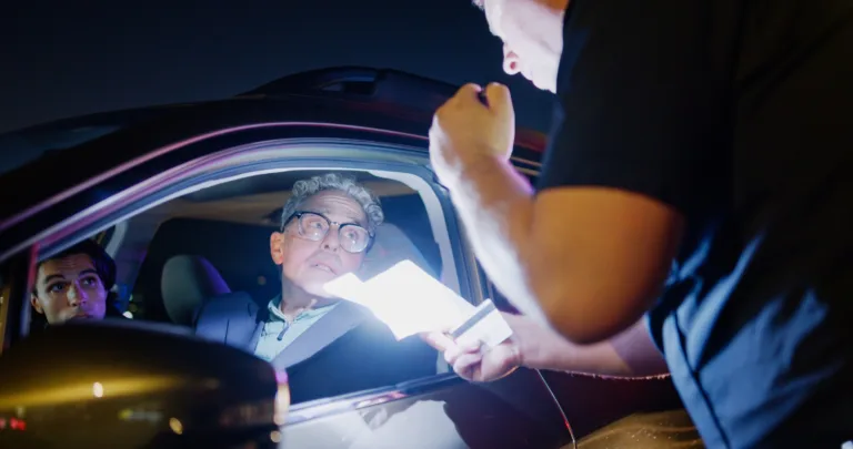 A police officer conducts a nighttime traffic stop