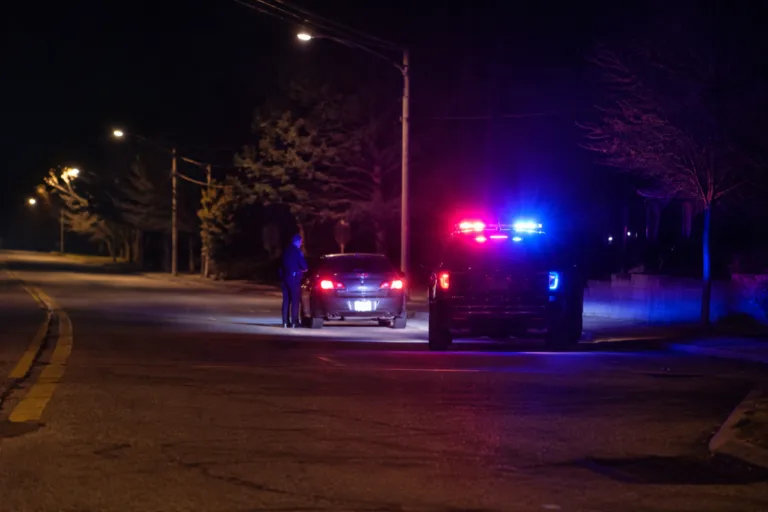 Michigan police officer conducting a roadside OWI stop at night