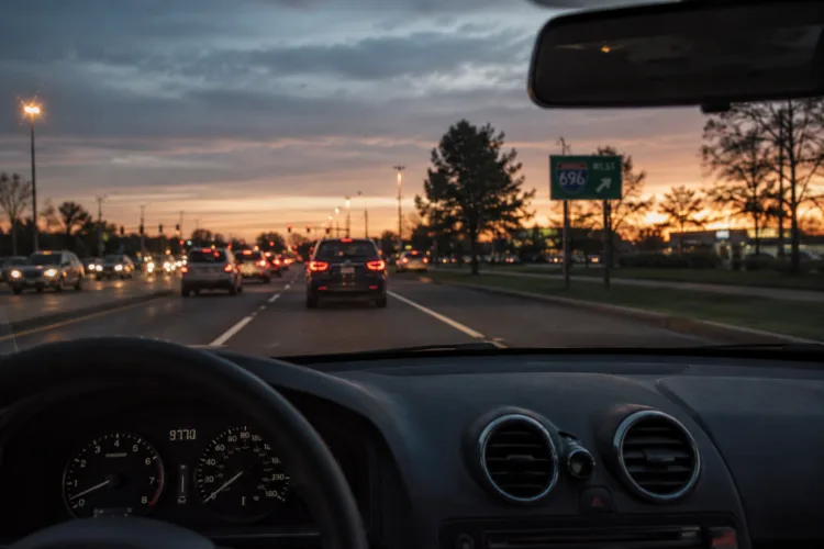 I-696 traffic at dusk, symbolizing DWLS penalties in Michigan for driving on a suspended license